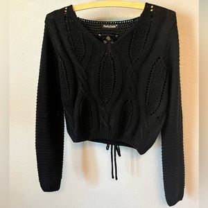 Black knit sweater with lace up back.